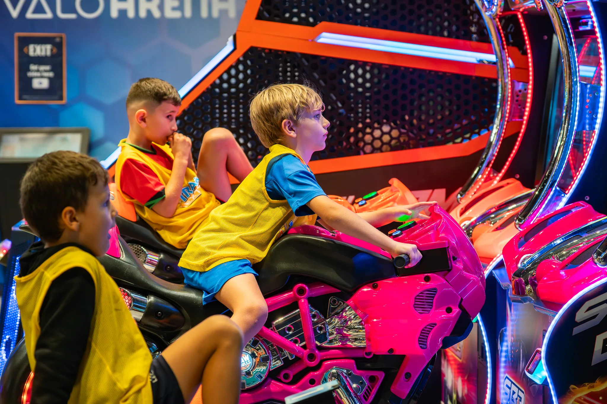 Kids playing racing games at Trampo arcade