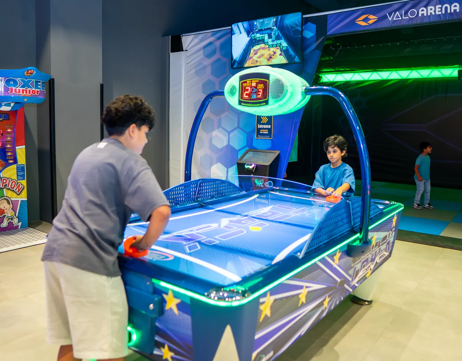 Kids enjoying arcade games at Trampo