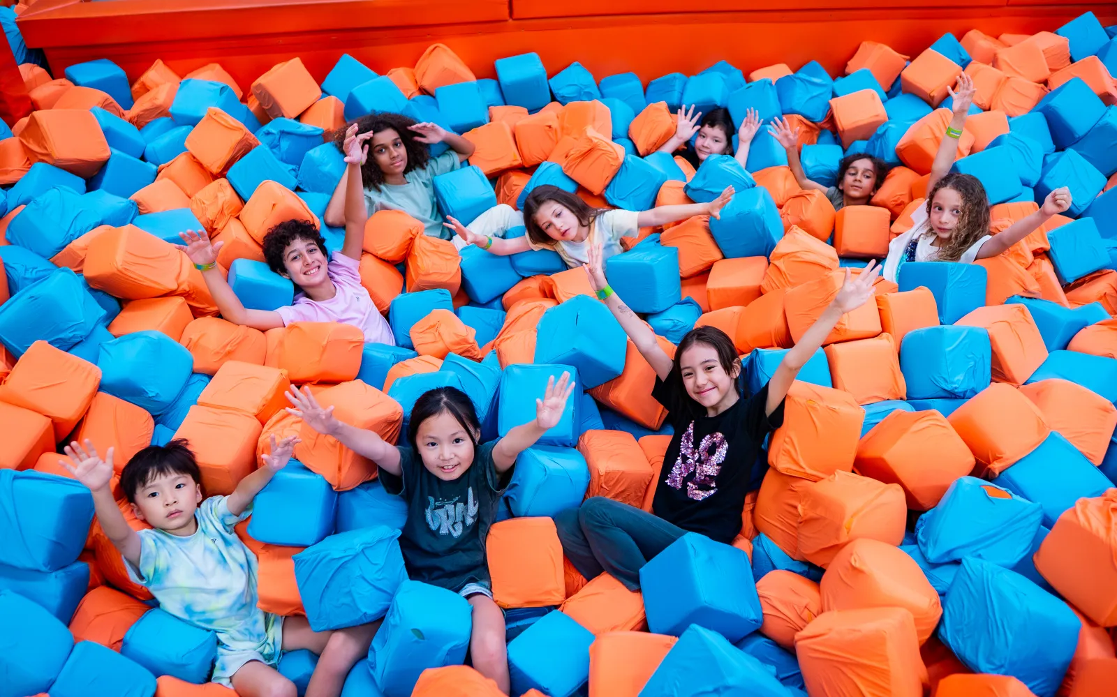 Kids diving into the foam pit at Trampo