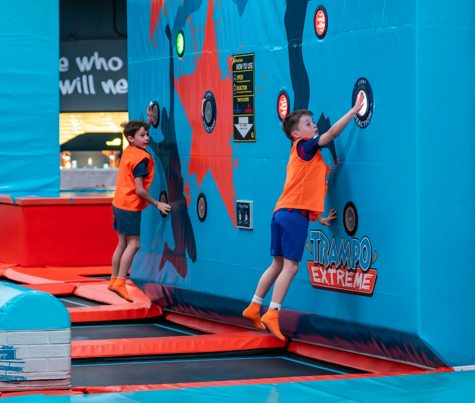 Kids jumping to reach illuminated targets on the interactive wall