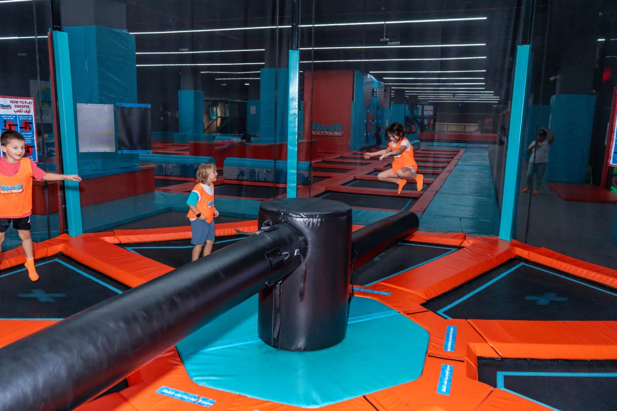 Kids jumping over the sweeper arm