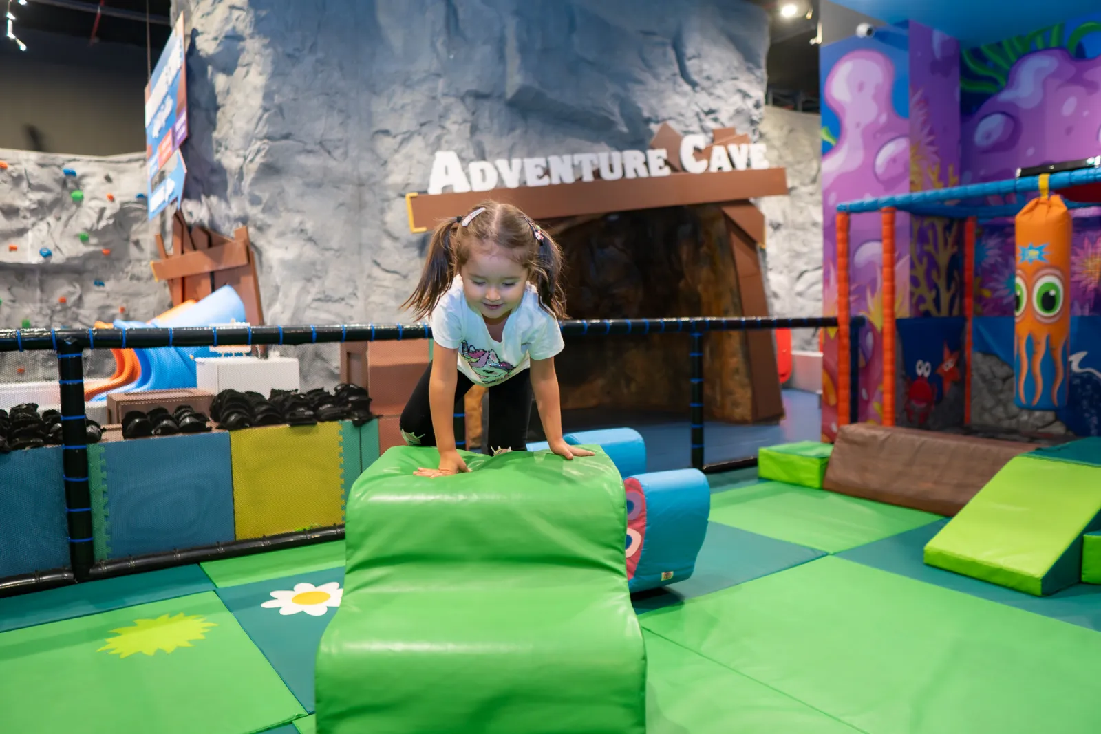 Toddler playing in the dedicated kids zone at Trampo