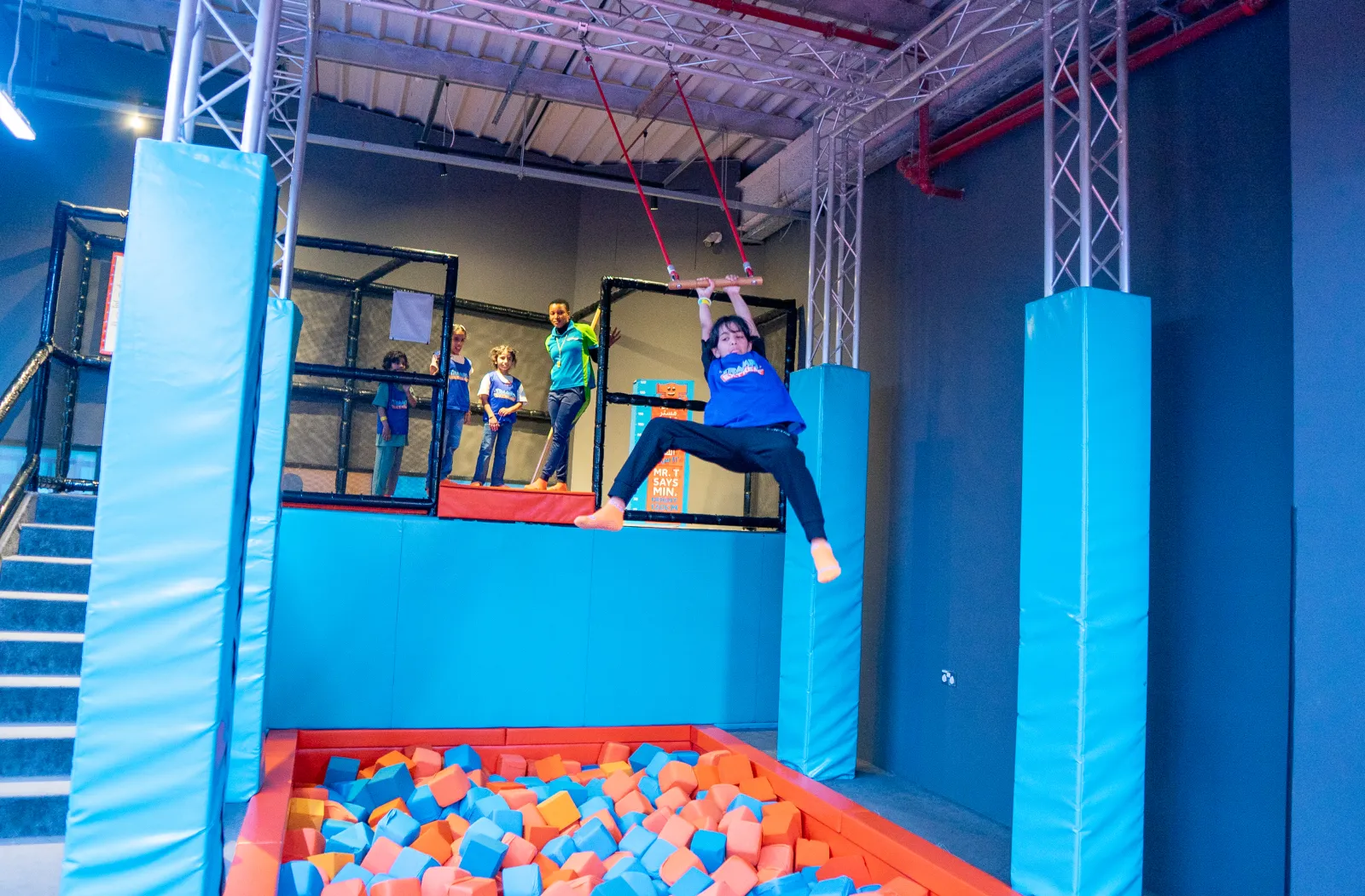 Swinging mid-air on the trapeze at Trampo