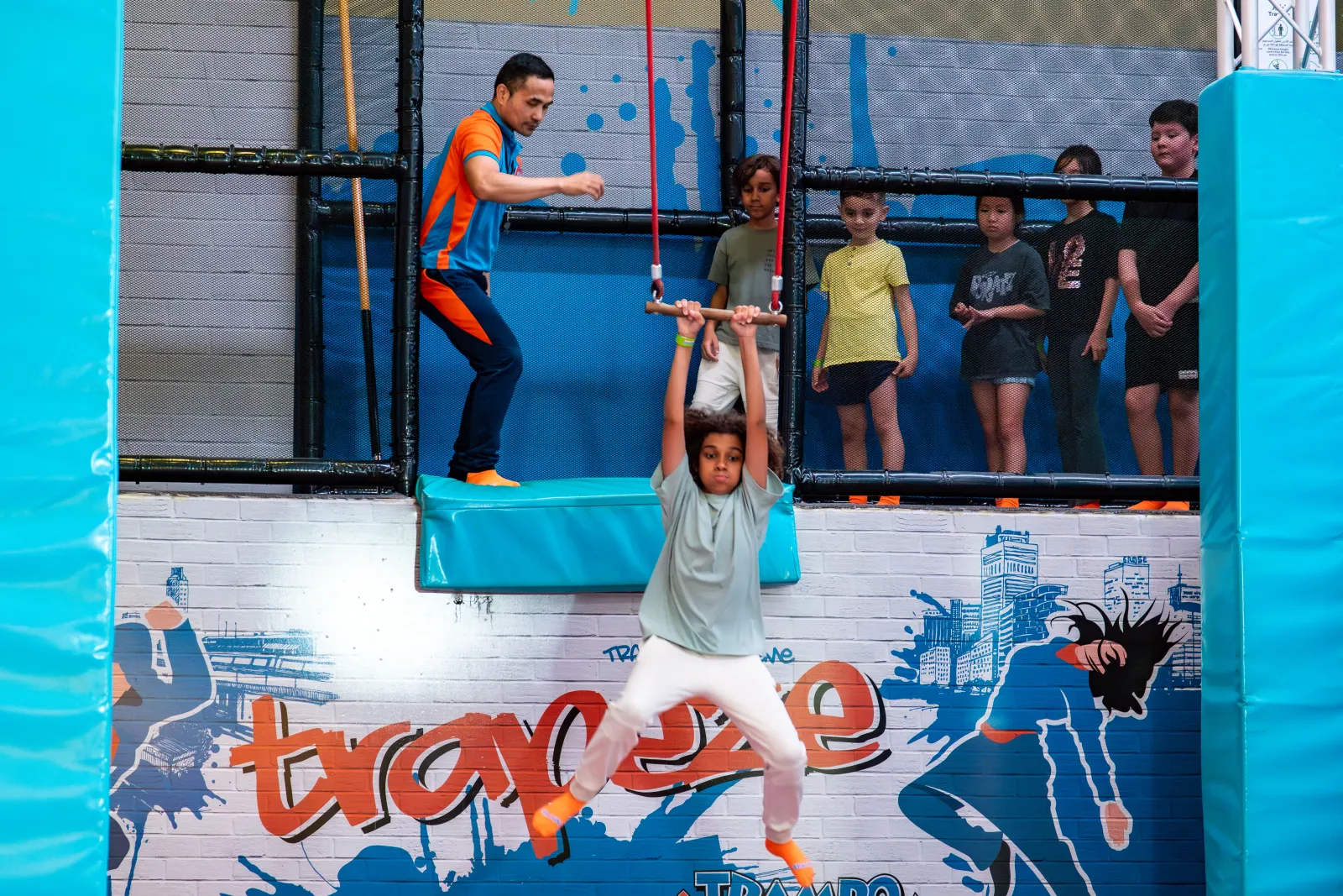 Trapeze course with spectators watching at Trampo